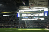 Fans at AT&T Stadium watch during the first half of an NFL wild-card playoff football game between the Dallas Cowboys and the San Francisco 49ers in Arlington, Texas, Sunday, Jan. 16, 2022. (AP Photo/Tony Gutierrez)