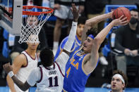 UCLA guard Jaime Jaquez Jr. (4) shoots over Gonzaga guard Joel Ayayi (11) during the first half of a men's Final Four NCAA college basketball tournament semifinal game, Saturday, April 3, 2021, at Lucas Oil Stadium in Indianapolis. (AP Photo/Michael Conroy)