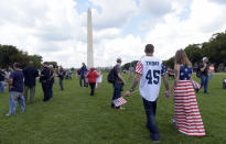 <p>Militia members hold each others backpacks during a pro-Trump “Mother of all Rallies” (MOAR) event on the National Mall in Washington on Saturday, Sept. 16, 2017. MOAR, the “Woodstock of American Rallies,” wants to send a message to Congress, the media and the world that the attendees stand to defend American values and culture. (Photo: Alex Wroblewski/Bloomberg via Getty Images) </p>