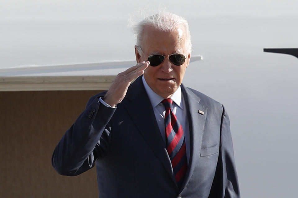 President Joe Biden returns a salute from the stairs of Air Force One, Monday, Dec. 11, 2023, at Andrews Air Force Base, Md., en route to Philadelphia. (AP Photo/Luis M. Alvarez)