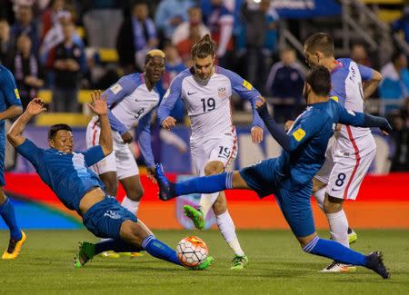 United States midfielder Graham Zusi (19) shoots the ball and scores his goal while Guatemala goalkeeper Paulo Motta (12) and defender Carlos Castrillo (13) defend in the second half of the game during the semifinal round of the 2018 FIFA World Cup qualifying soccer tournament at MAPFRE Stadium. Trevor Ruszkowski-USA TODAY Sports