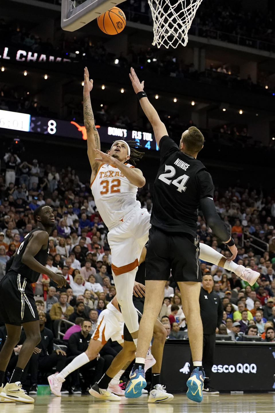 Texas forward Christian Bishop shoots over Xavier forward Jack Nunge in the first half of a Sweet 16 college basketball game in the Midwest Regional of the NCAA Tournament Friday, March 24, 2023, in Kansas City, Mo. (AP Photo/Jeff Roberson)