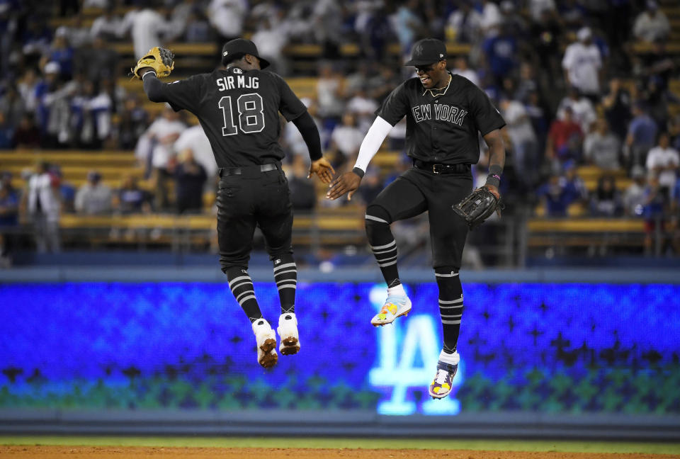 New York Yankees' Didi Gregorius, left, and Cameron Maybin celebrate after the Yankees defeated the Los Angeles Dodgers 10-2 in a baseball game, Friday, Aug. 23, 2019, in Los Angeles. (AP Photo/Mark J. Terrill)