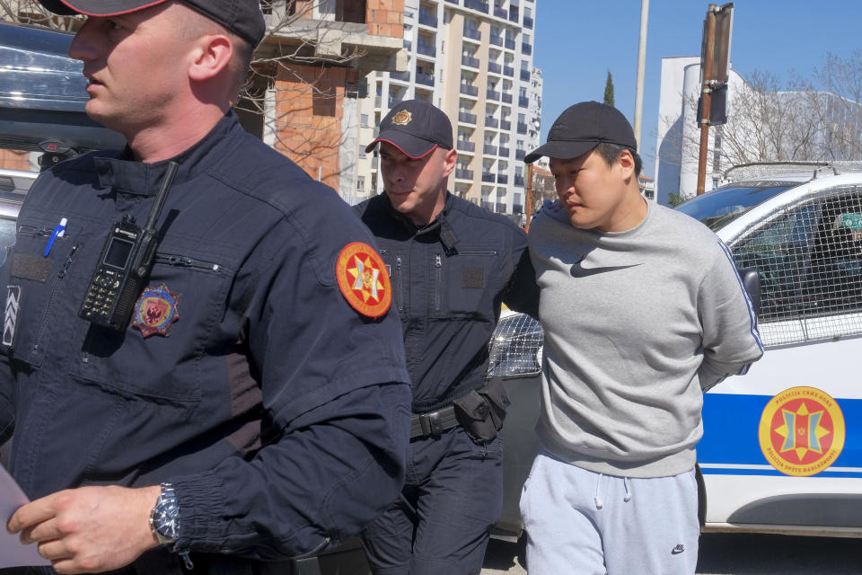 Montenegrin police officers escort an individual who is believed to be one of the most wanted fugitives, South Korean citizen, Terraform Labs founder Do Kwon in Montenegro's capital Podgorica, Friday, March 24, 2023. South Korea's Justice Ministry on Friday confirmed the arrest of Kwon and another unidentified individual linked to the cryptocurrency crash and said it will proceed with steps to extradite them to South Korea. Both South Korea and Montenegro are signees to the European Convention on Extradition. (AP Photo/Risto Bozovic)