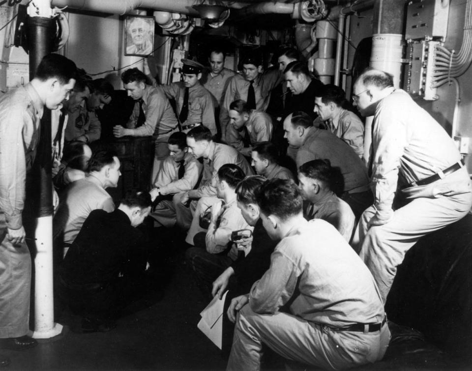 Oficiales de la marina escuchan el discurso de Roosevelt en el Congreso pidiendo que se declarara la guerra