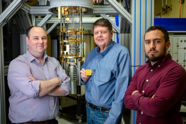 The AWS Center for Quantum Computing is led by Oskar Painter, head of quantum hardware, at left; and Fernando Brandao, head of quantum algorithms, at right. Bill Vass, AWS’ vice president of technology, stands between them, holding a packaged AWS quantum processor. (AWS Photo)