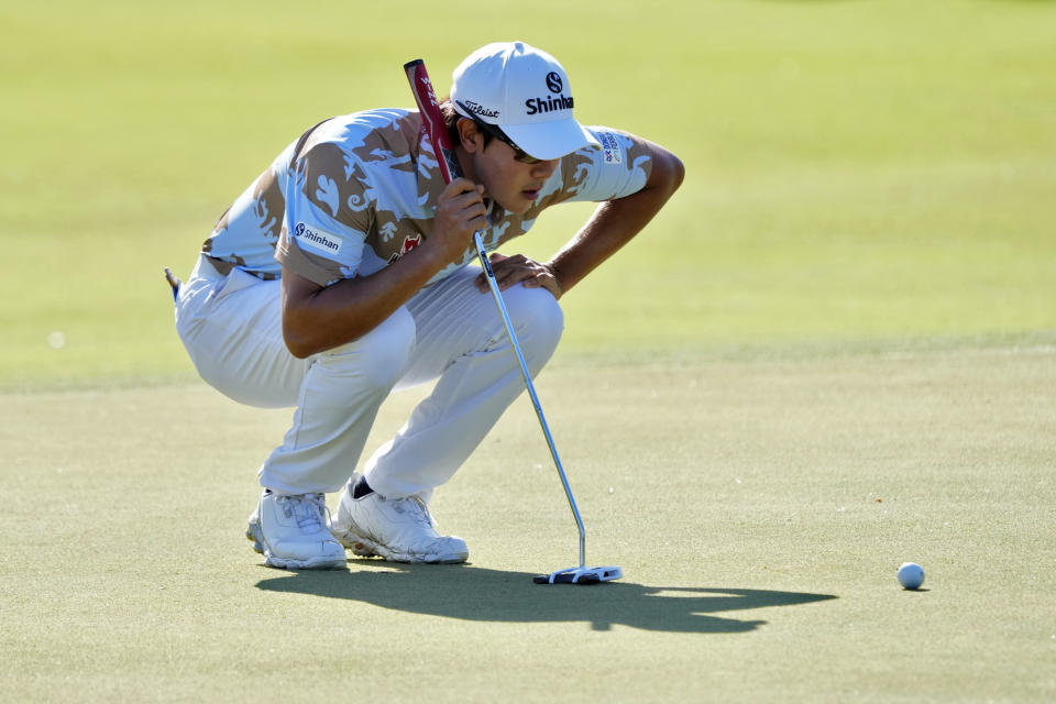 S.H. Kim lines up his putt on the first green during the third round of the Sony Open golf tournament, Saturday, Jan. 14, 2023, at Waialae Country Club in Honolulu. (AP Photo/Matt York)