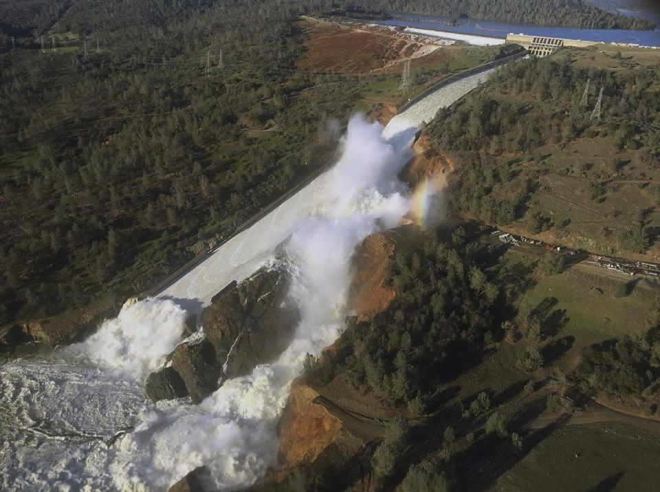 <p>This Saturday, Feb. 11, 2017, aerial photo released by the California Department of Water Resources shows the damaged spillway with eroded hillside in Oroville, Calif. Water will continue to flow over an emergency spillway at the nation’s tallest dam for another day or so, officials said Sunday. (William Croyle/California Department of Water Resources via AP) </p>