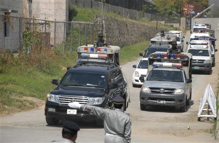 A convoy of police vehicles escort the vehicle (front) transporting former Pakistani President Pervez Musharraf as he leaves after appearing before the Special Court formed to try him for treason in Islamabad March 31, 2014. REUTERS/Stringer