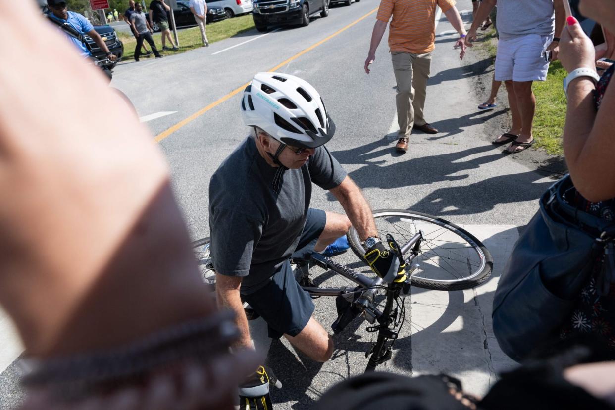 US President Joe Biden falls off his bicycle as he approaches well-wishers following a bike ride at Gordon's Pond State Park in Rehoboth Beach, Delaware, on June 18, 2022. - Biden took a tumble as he was riding his bicycle Saturday morning, but was unhurt. (Photo by SAUL LOEB / AFP) (Photo by SAUL LOEB/AFP via Getty Images)