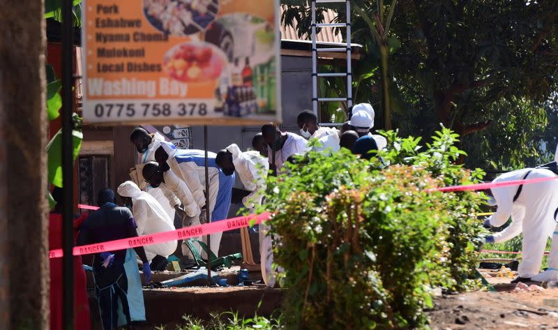 FILE PHOTO: Ugandan explosives experts inspect the debris at the scene of an explosion in Komamboga, on the northern outskirts of Kampala