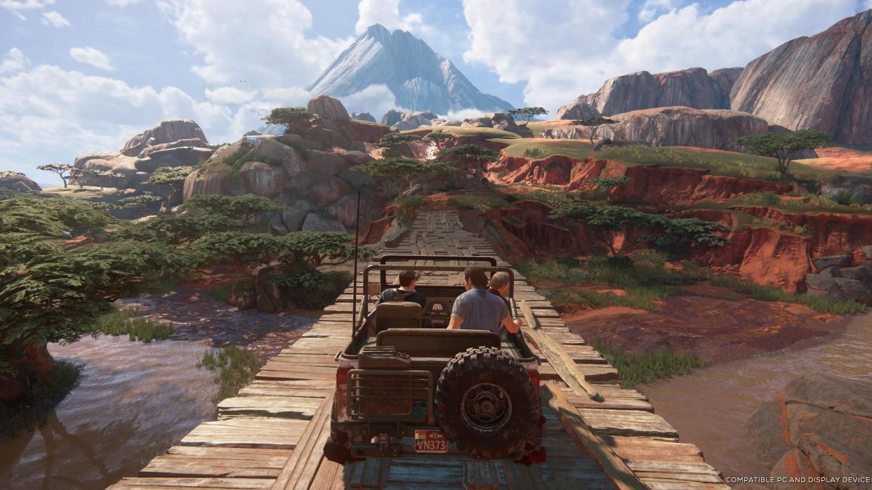  uncharted legacy of thieves collection image, a jeep drives across a wooden bridge in a red-rock valley with scrubby trees 