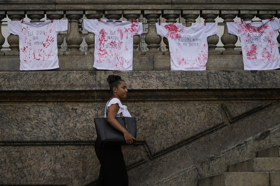 Camisetas marcadas con tinta roja colgadas fuera del edificio del Consejo Municipal, colocadas por manifestantes en protesta contra los feminicidios en el Día Internacional de la Mujer en Rio de Janeiro, Brasil, el viernes 8 de marzo de 2024. (AP Foto/Silvia Izquierdo)