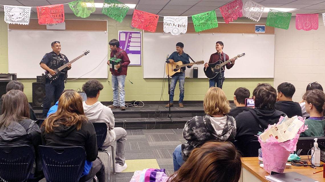 Martinez, left, plays Spanish music on bass guitar with students at Canyon Springs High. As a former alternative school student himself, Martinez hopes he has made an impact on the students.