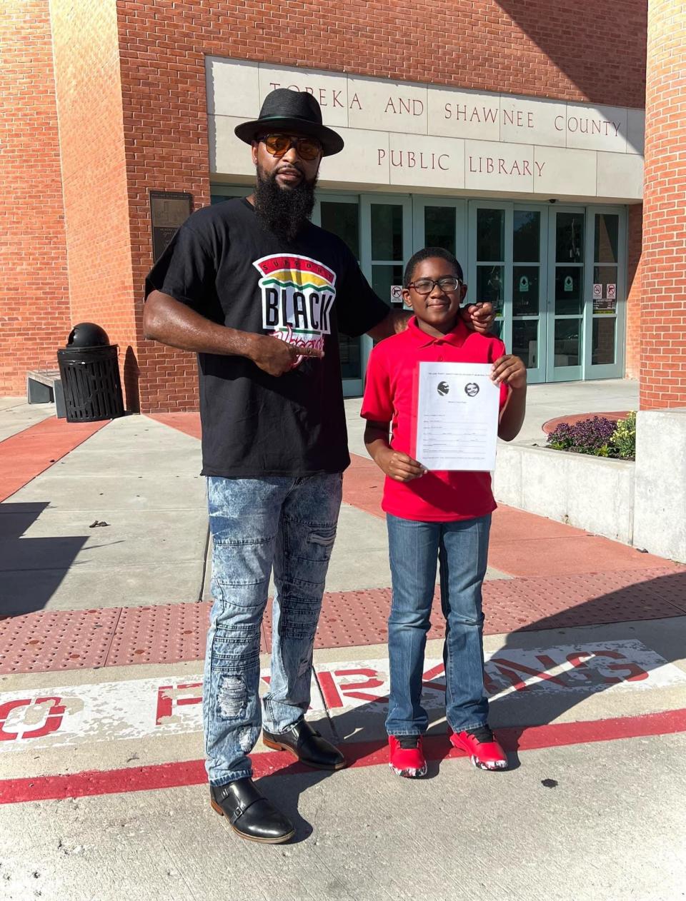 Chris Ware, left, and Jerel D. McGeachy Jr. stood together in front of the Topeka & Shawnee County Public Library during one of Jerel's speaking appearances in Topeka. Jerel was found shot to death April 1 in his home.