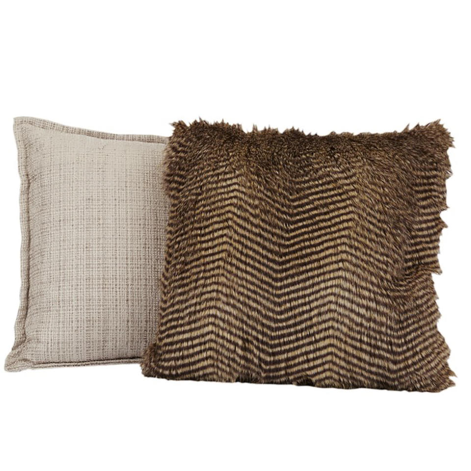 This image provided by HomeGoods shows faux fur pillows. Marcy Blum, a NY-based wedding and event planner suggests filling a basket with throws and pillows for guests who will be gathering outdoors during your Noon Year's Eve bash. (HomeGoods via AP)