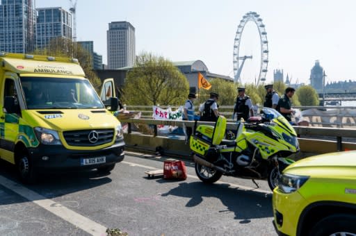 Police officers and ambulance personnel attend a medical incident at the climate change activist's camp on Waterloo Bridge in London