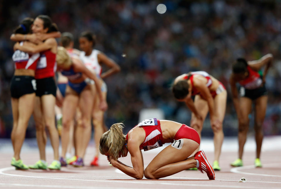 Morgan Uceny of the United States reacts after falling as athletes celebrate behind her during the Women's 1500m Final on Day 14 of the London 2012 Olympic Games at Olympic Stadium on August 10, 2012 in London, England. (Photo by Jamie Squire/Getty Images)