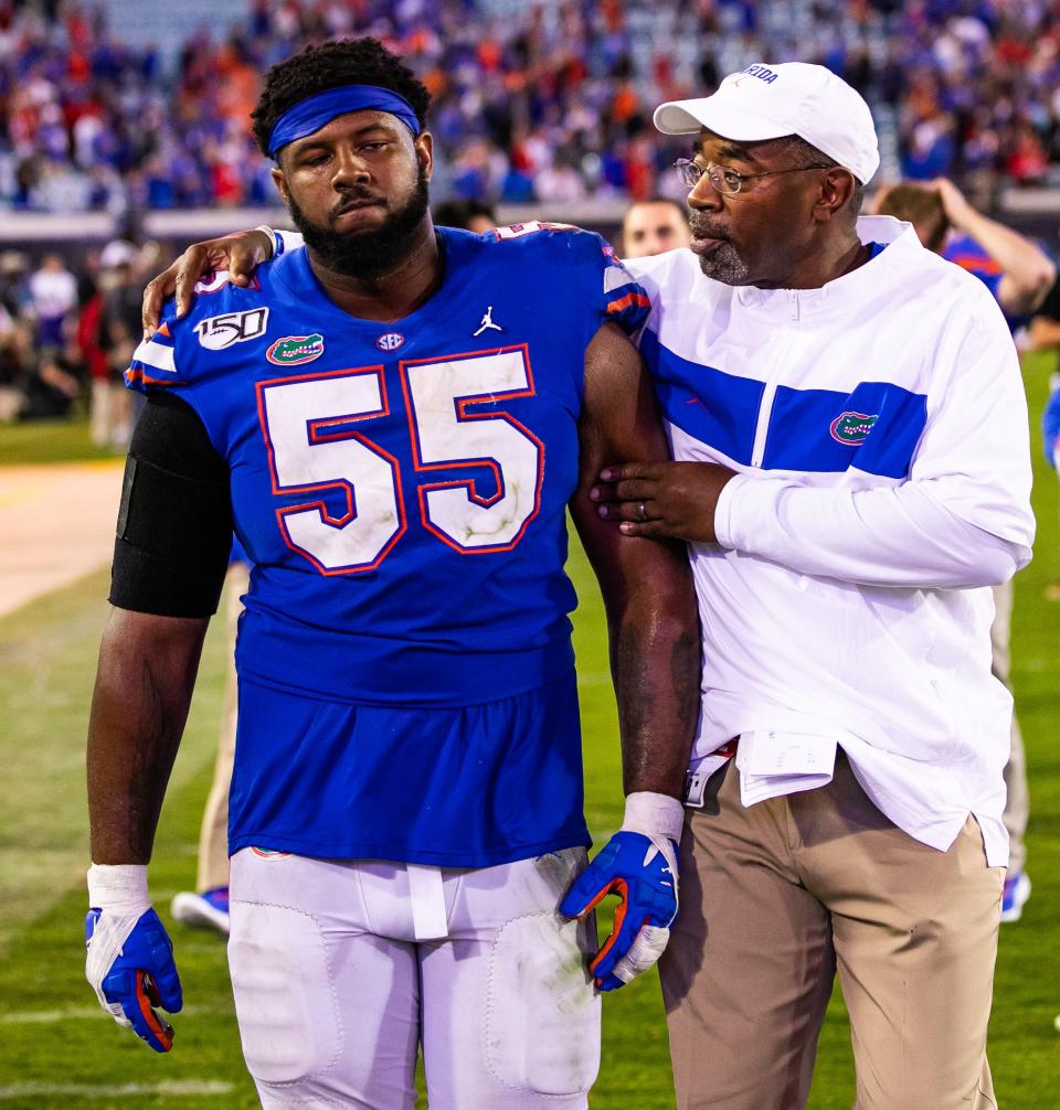 Defensive Line Coach David Turner consoles Florida Gators defensive lineman Kyree Campbell (55) after the Georgia Bulldogs defeated the Florida Gators 24-17 at TIAA Bank Field Saturday, November 2, 2019 in Jacksonville, FL. [Doug Engle/Gainesville Sun]2019