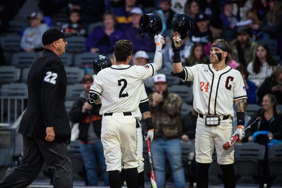Campbell's Trenton Harris (2)  taps helmets with Jarrod Belbin after hitting a home run during the third inning against East Carolina on Wednesday, March 22, 2023, at Segra Stadium.