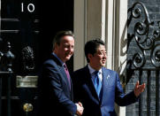 Britain's Prime Minister David Cameron (L) greets his Japanese counterpart Shinzo Abe as he arrives at Number 10 Downing Street in London, Britain May 5, 2016. REUTERS/Stefan Wermuth