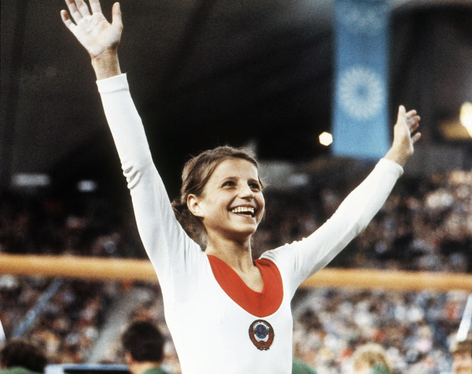 FILE - In this Aug. 1972, file photo, Olga Korbut, of Russia, throws up her arms in joy after winning the Individual Women's Gymnastic event at the 1972 Summer Olympics in Munich, Germany. (AP Photo/File)