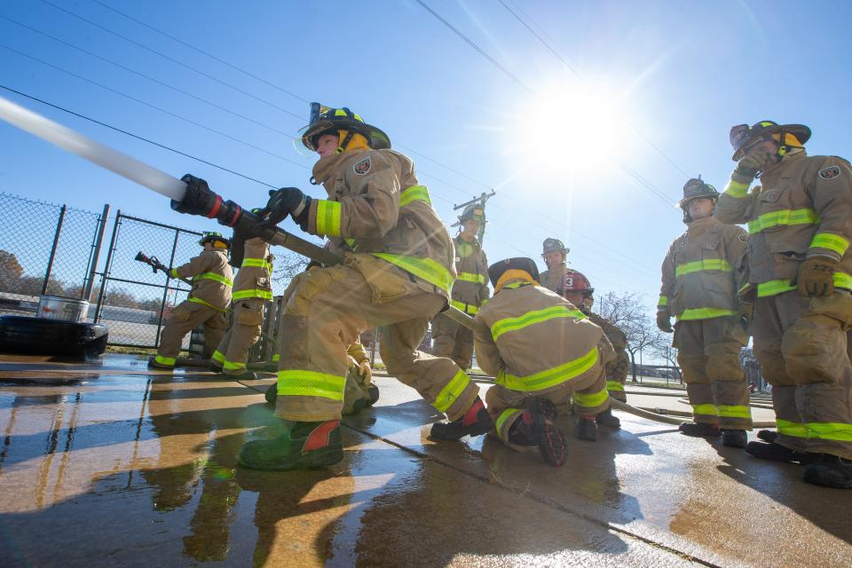 Topeka Fire Department recruits work on hose control and technique during fire academy training in 2021 at the fire department headquarters at 324 S.E. Jefferson.
