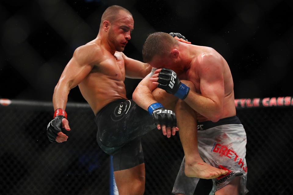 Eddie Alvarez (L) knees Justin Gaethje during their lightweight fight Saturday at UFC 218 in Detroit. Alvarez stopped Gaethje at 3:59 of the third round. (Getty Images)