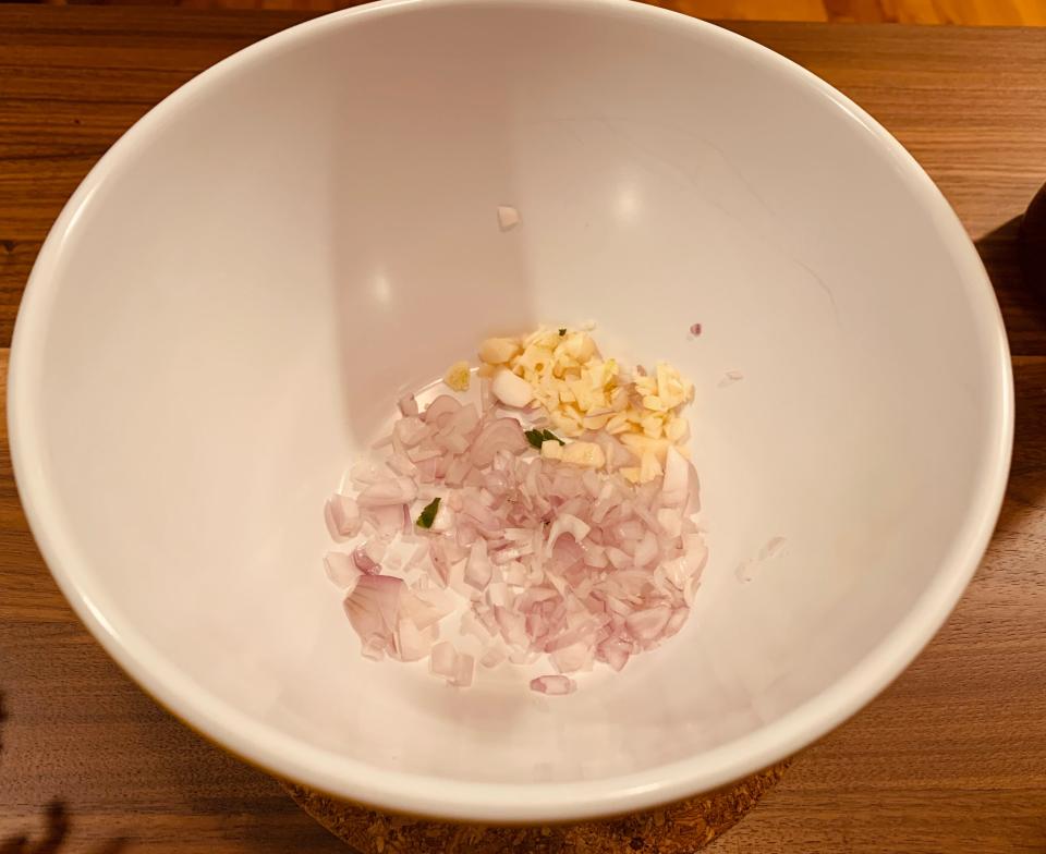 minced shallots and produce in white bowl