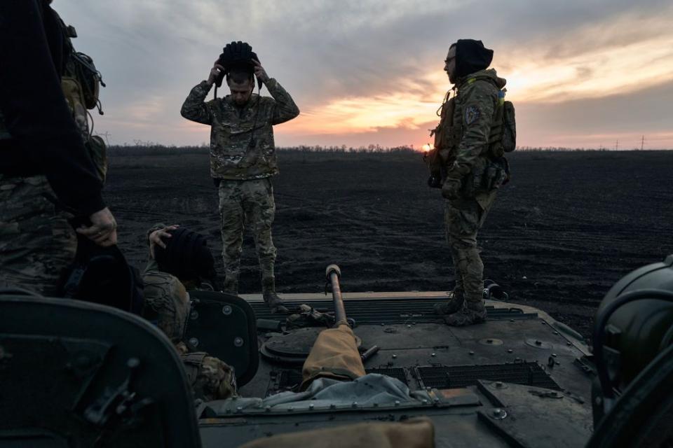 Ukrainian soldiers sit on an armored vehicle in the outskirts of Avdiivka, Ukraine, on Feb. 14, 2024(Vlada Liberova/Libkos/Getty Images)