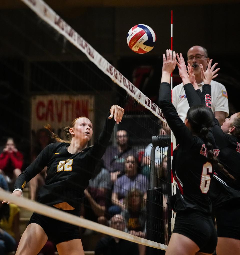 Dripping Springs outside hitter Henley Anderson sends a shot over the net during Tuesday night's match.