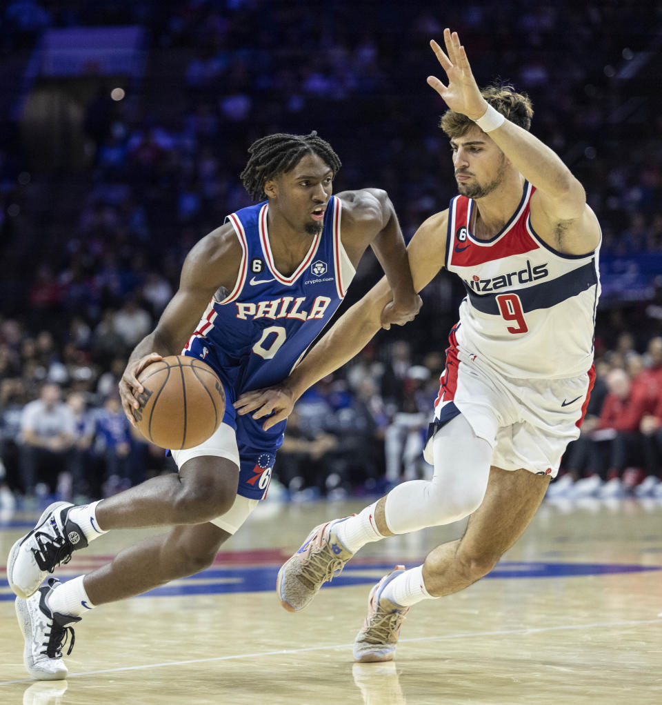 Philadelphia 76ers guard Tyrese Maxey (0) moves past Washington Wizards forward Deni Avdija (9) during the second half of an NBA basketball game Wednesday, Nov. 2, 2022, in Philadelphia. (AP Photo/Laurence Kesterson)