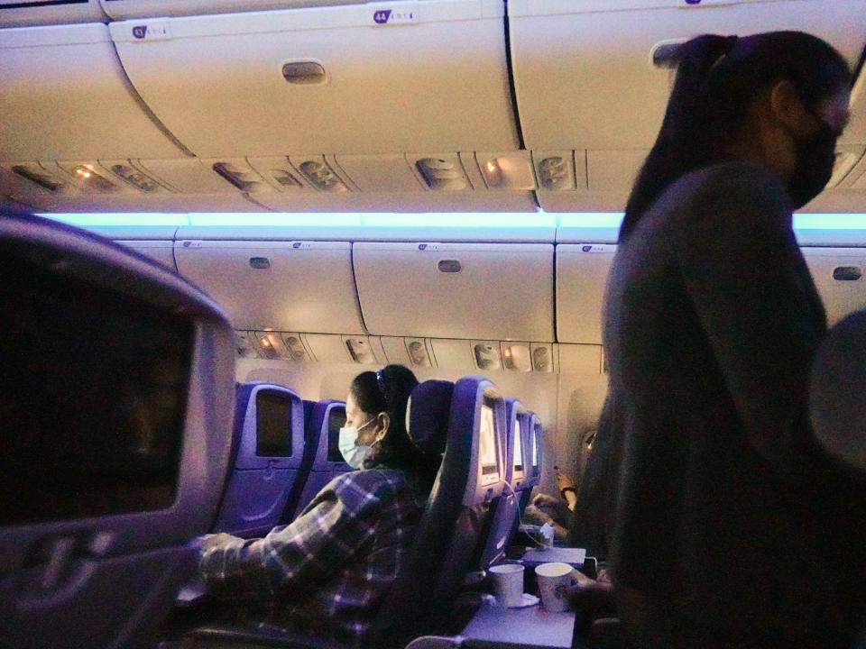 People on a dimly-lit flight