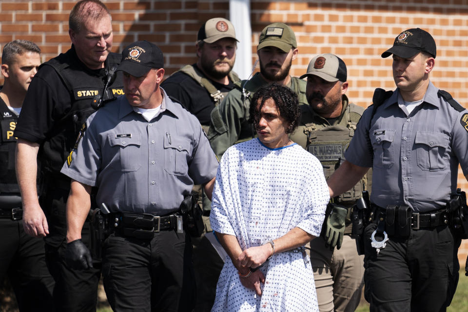 Law enforcement officers escort Danelo Cavalcante from a Pennsylvania State Police barracks in Avondale Pa., on Wednesday, Sept. 13, 2023. Cavalcante was captured Wednesday after eluding hundreds of searchers for two weeks. (AP Photo/Matt Rourke)