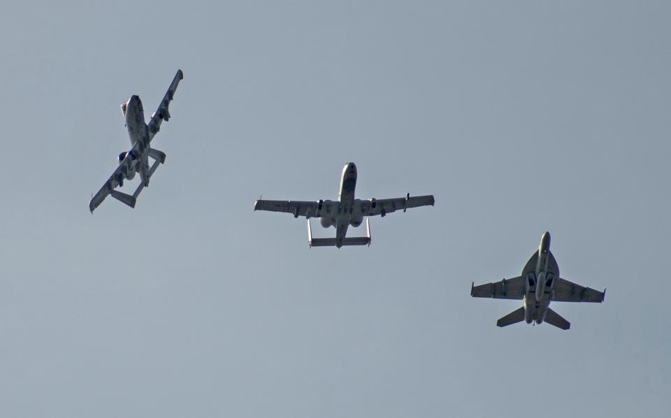 A-10s and a Super Hornet perform an overhead formation break after a sortie from Gowen Field. (U.S. Air National Guard photo by Master Sgt. Joshua C. Allmaras)