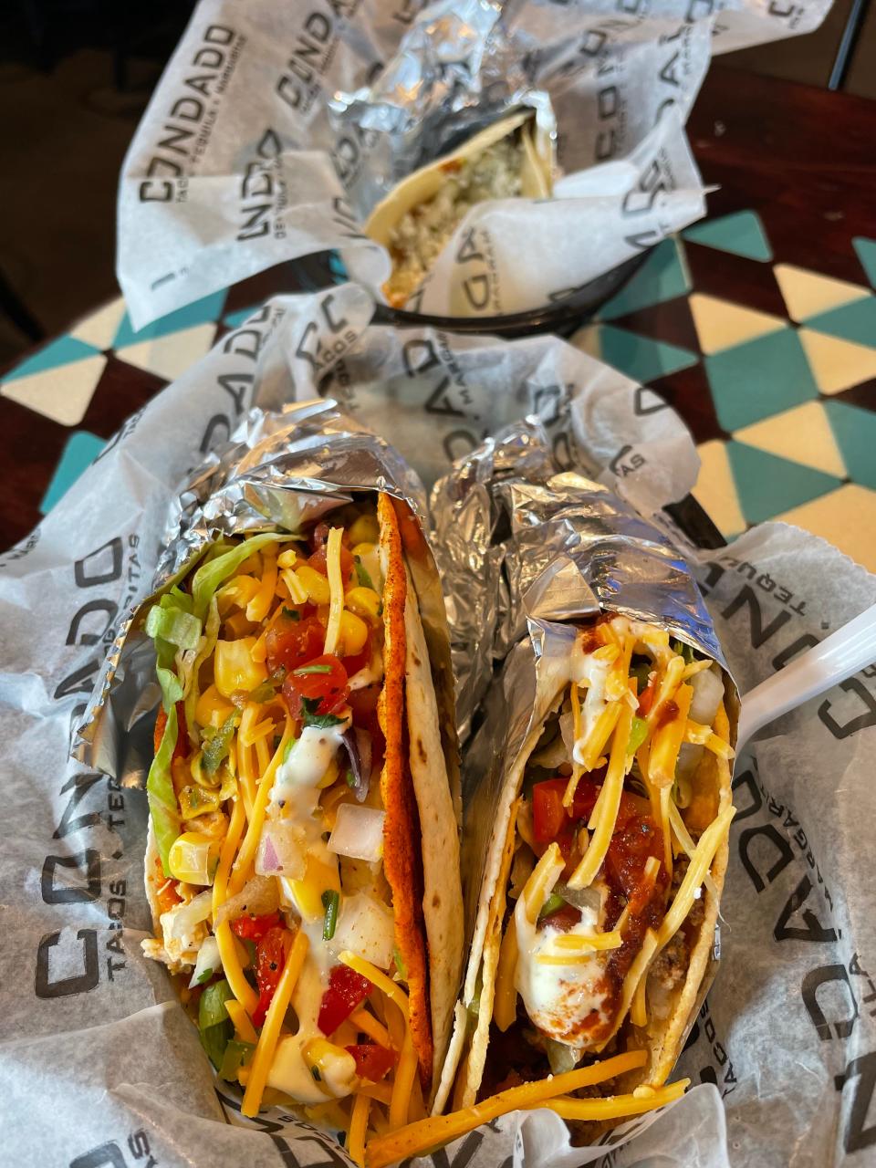 Flavorful tacos such as the Lucy’s Fire and Cali Green at Condado Tacos include chicken, lettuce, cilantro, onions, smoked cheddar, corn salsa and cilantro-lime aioli.