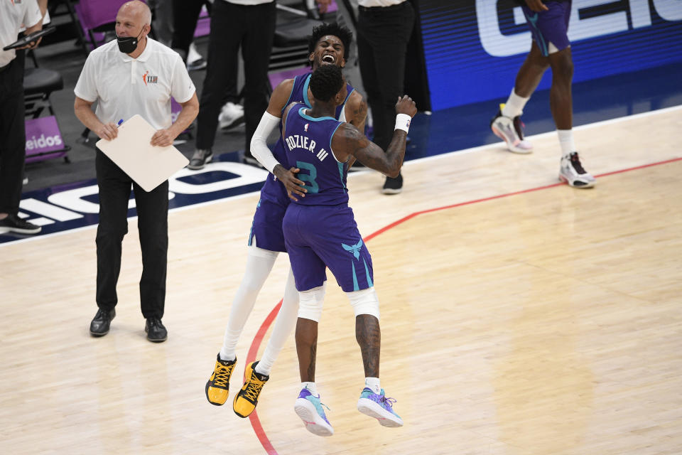 Charlotte Hornets forward Jalen McDaniels, back, reacts with guard Terry Rozier (3) after he made a three-point basket during the second half of an NBA basketball game against the Washington Wizards, Sunday, May 16, 2021, in Washington. (AP Photo/Nick Wass)