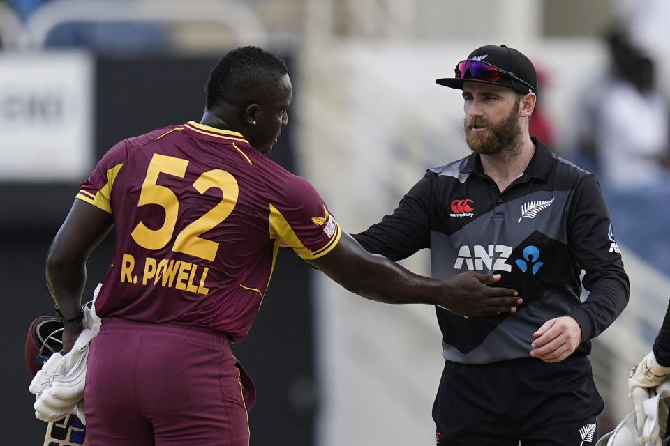 New Zealand's captain Kane Williamson congratulates West Indies' captain Rovman Powell at the end of their third and last T20 cricket match at Sabina Park in Kingston, Jamaica, Sunday, Aug. 14, 2022. West Indies won by 8 wickets. (AP Photo/Ramon Espinosa)