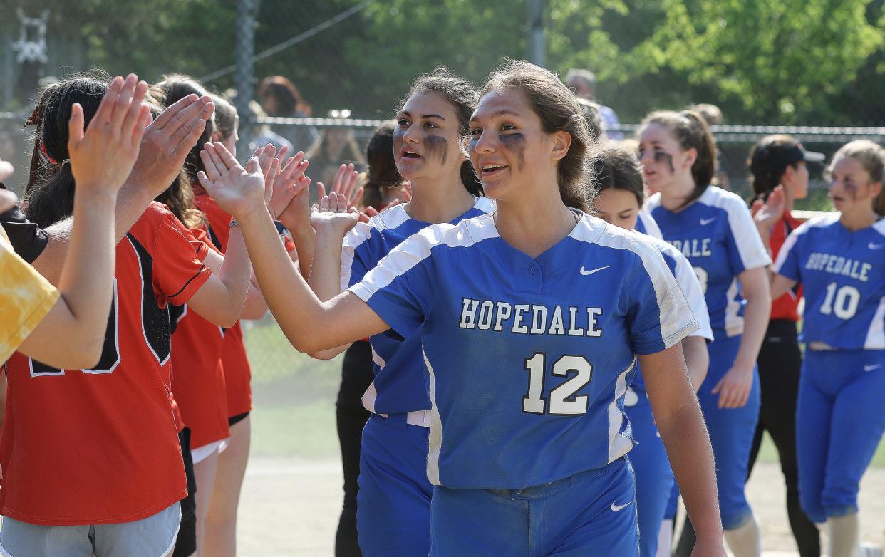 Hopedale pitcher Lizzie Brytowski leads her team down the line congratulating Maynard on their 5-3 win, May 31, 2022.