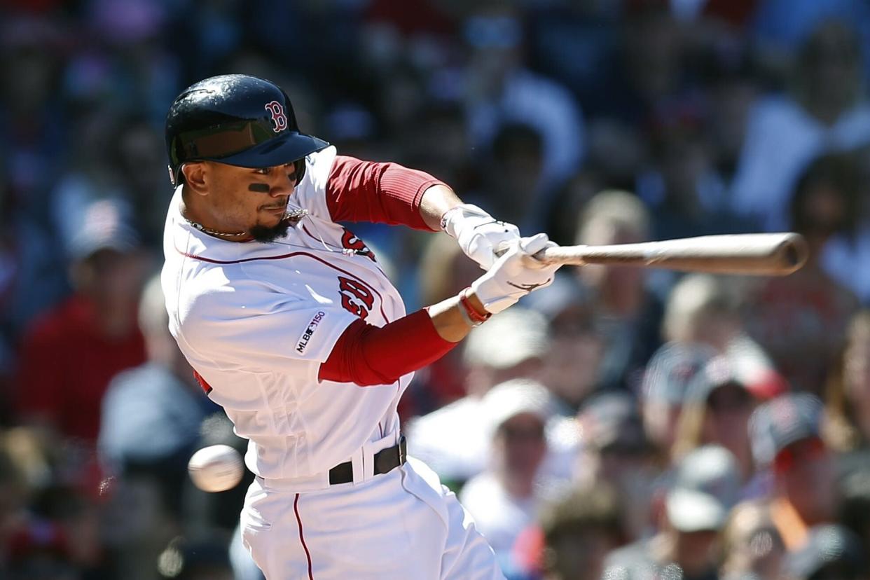 Boston Red Sox's Mookie Betts swings for a strike during the fifth inning of a baseball game against the Seattle Mariners in Boston, Saturday, May 11, 2019. (AP Photo/Michael Dwyer)