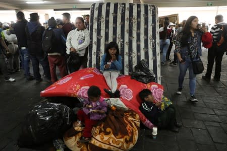 Children eat as people gather in the aftermath of the last days' protests, after the government of Ecuadorian President Lenin Moreno agreed to repeal a decree that ended fuel subsidies, in Quito