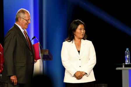 Peru's presidential candidates Pedro Pablo Kuczynski and Keiko Fujimori attend a presidential debate in Lima, Peru, April 3, 2016. REUTERS/Mariana Bazo