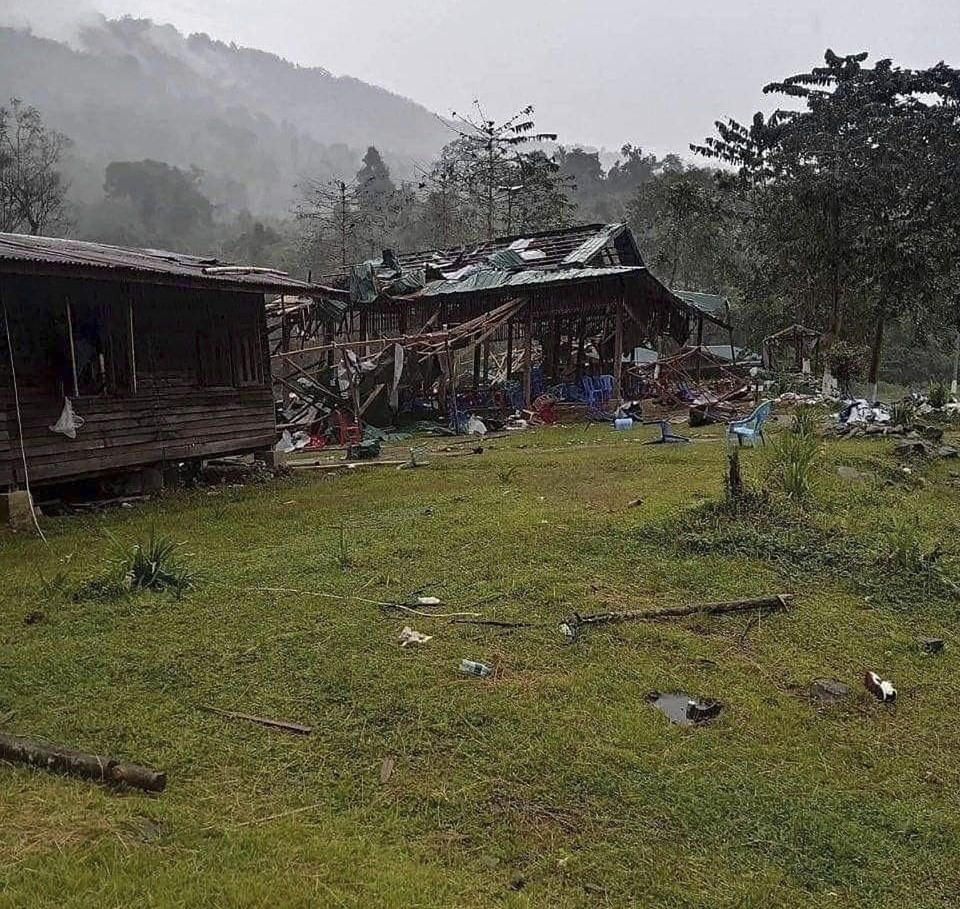 Debris are scattered around destroyed wooden structures near Aung Bar Lay Village, Hpakant township, Kachin state in Myanmar Monday, Oct. 24, 2022. Air strikes by Myanmar’s military killed scores of people, including singers and musicians, attending an anniversary celebration of the Kachin ethnic minority’s main political organization, members of the group and a rescue worker said Monday. (AP Photo)