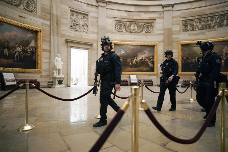 Law enforcement members walk in the Rotunda of the U.S. Capitol after rioters loyal to President Donald Trump stormed the U.S. Capitol in Washington, Wednesday, Jan. 6, 2021. (AP Photo/J. Scott Applewhite)