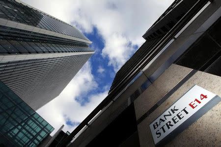 FILE PHOTO: A sign for Bank Street and high rise offices are pictured in the financial district Canary Wharf in London October 21, 2010. REUTERS/Luke MacGregor