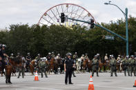 <p>Police officers in riot gear stand guard near the Disneyland theme park as people gather to protest against Republican presidential candidate Donald Trump, May 25, 2016, in Anaheim, Calif. (AP Photo/Jae C. Hong) </p>