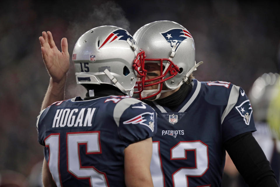 New England Patriots quarterback Tom Brady, right, celebrates his touchdown pass to Chris Hogan against the Titans. (AP)