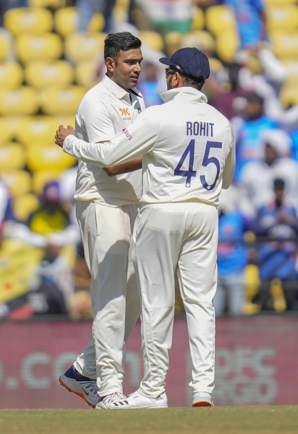 India's Ravichandran Ashwin, left, gets a tap on the shoulder from captain Rohit Sharma for his five-wicket haul during the third day of the first cricket test match between India and Australia in Nagpur, India, Saturday, Feb. 11, 2023. (AP Photo/Rafiq Maqbool)