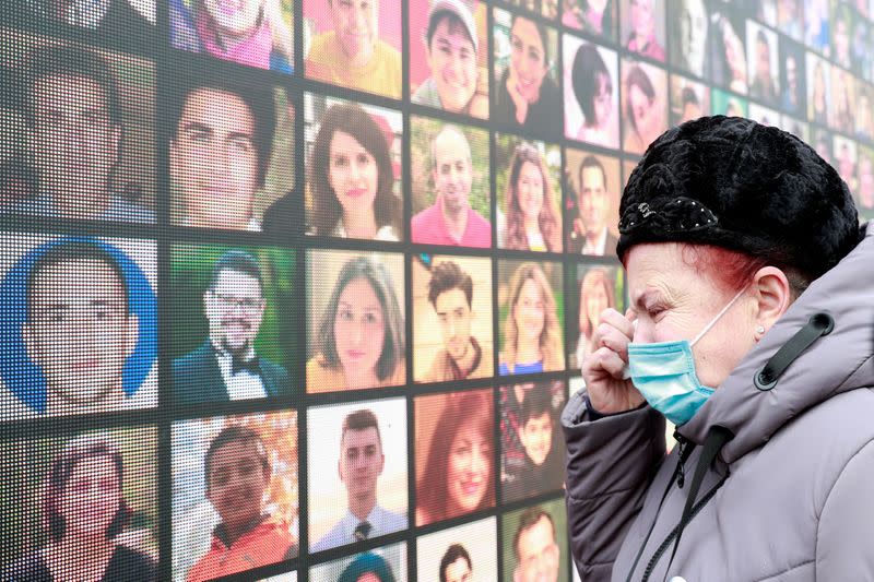 FILE PHOTO: A woman attends a commemorative ceremony marking the first anniversary of flight PS752 downing in Kyiv