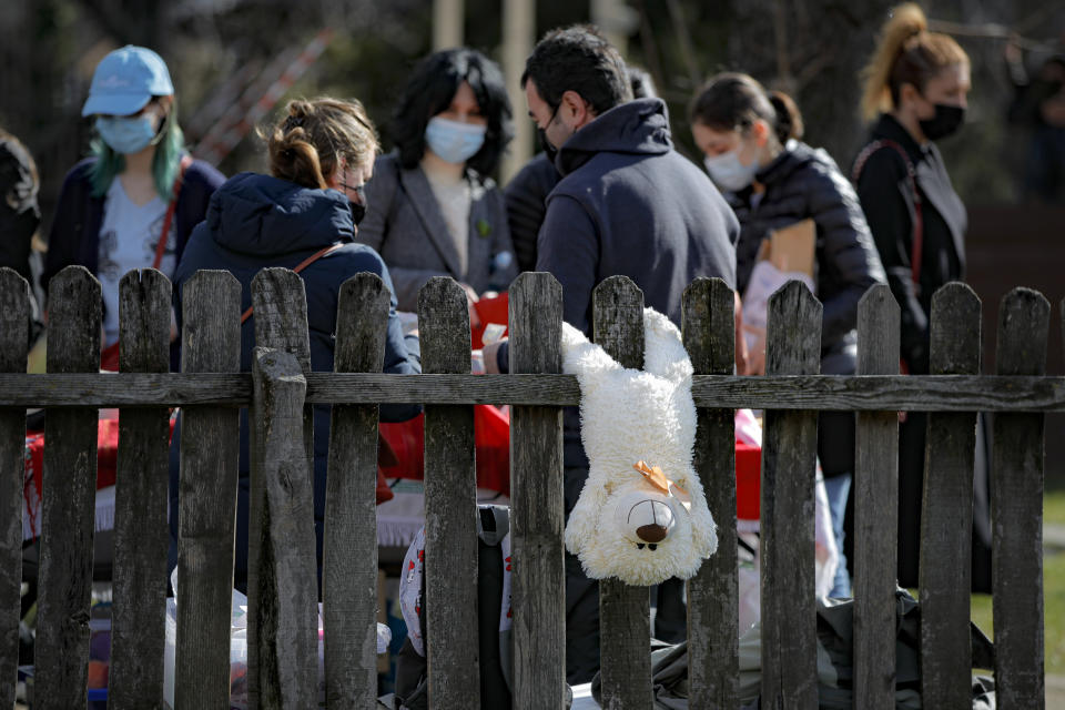 A teddy bear hangs from a fence at a spring charms fair at the Dimitrie Gusti Village Museum in Bucharest, Romania, Sunday, Feb. 28, 2021. (AP Photo/Vadim Ghirda)